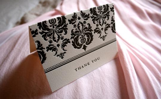 A fancy Thank You card on a pink background